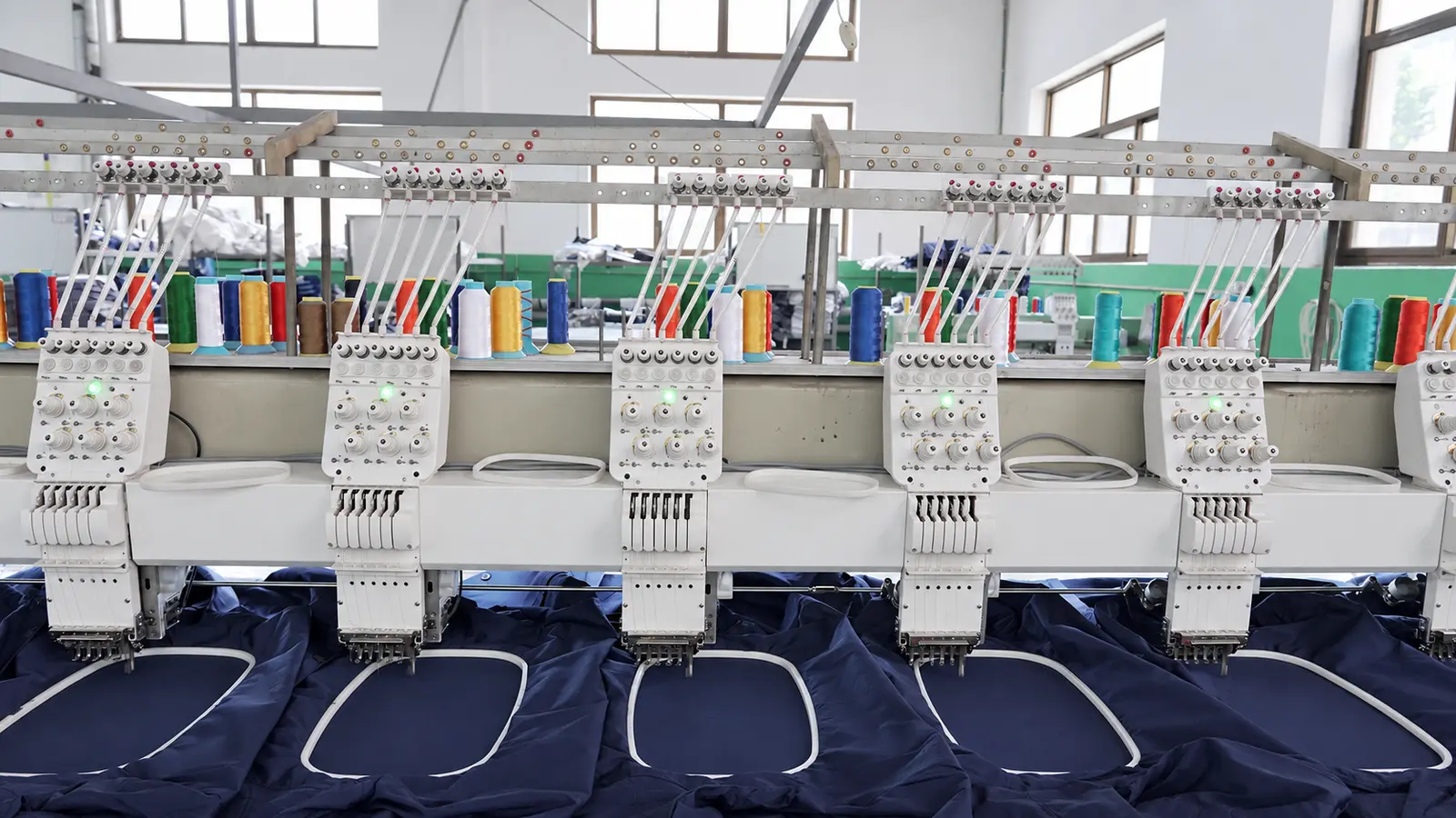 Embroidery equipment processing navy workwear